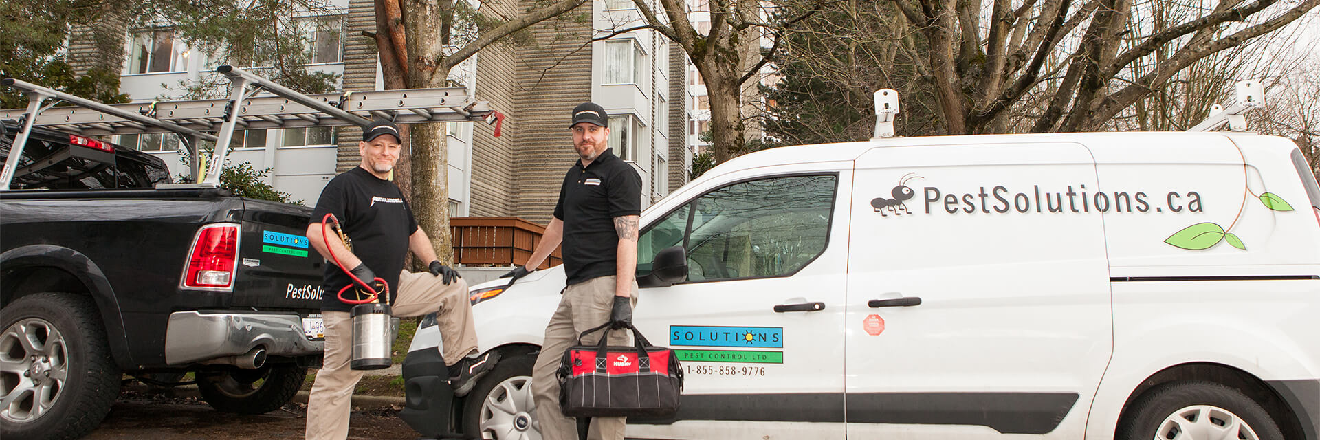 Solutions Pest Control service tech gearing up from their trucks